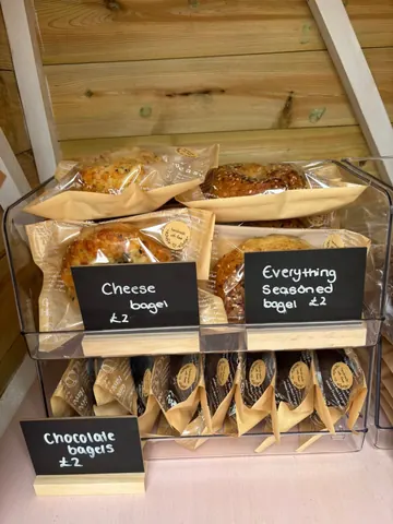 A display of bagels and baked goods.