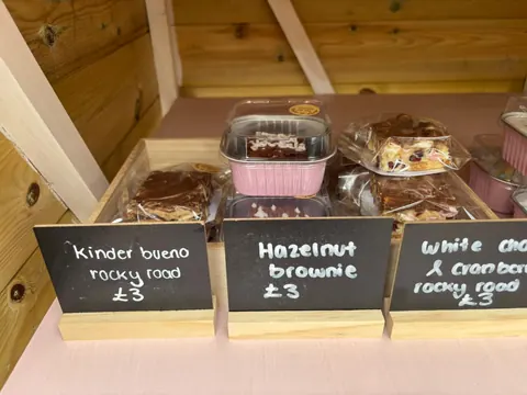A display of various desserts including brownies, white chocolate, and hazelnut.