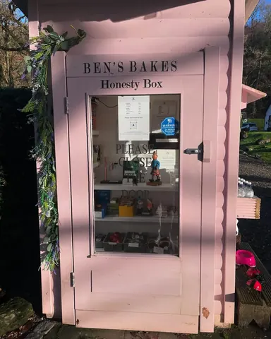 A pink building with a sign that says "Bens Bakes" on it.