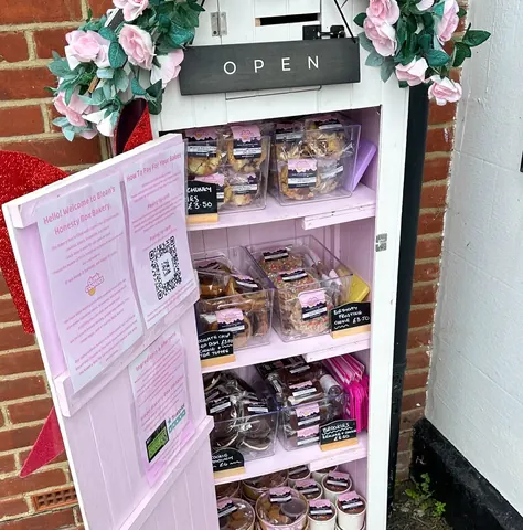 A pink box with a sign that says "open" on it.