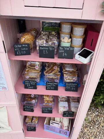 A pink cabinet with a sign that says "Cereal Milk" on it.