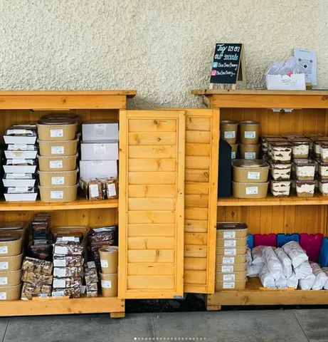 A wooden display case with a sign that says "Food of the Gods" in front of it.