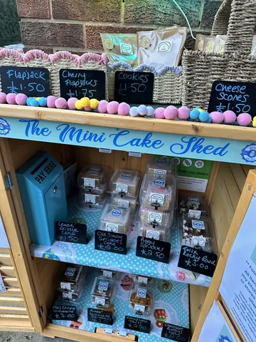 A small cake shop with a variety of cakes and cookies.