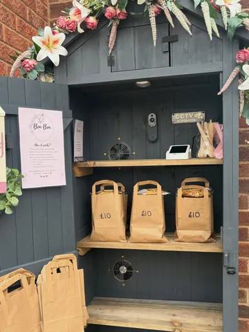 A small wooden shed with a sign that says "Bake & Blend".
