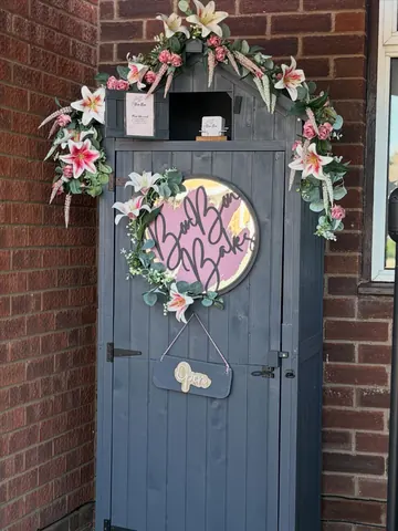 A blue wooden door with a wreath on it.
