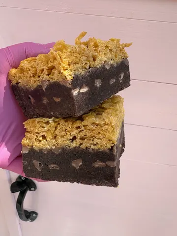 A person is holding a piece of cake.