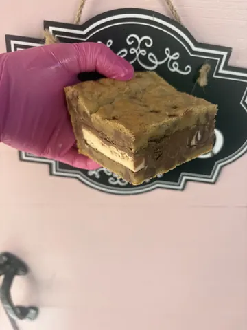 A person is holding a piece of cake.