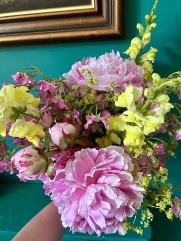 A bouquet of flowers with a pink flower in the center.