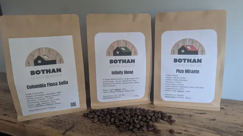 Three bags of coffee are labeled with the name BOTHAN.