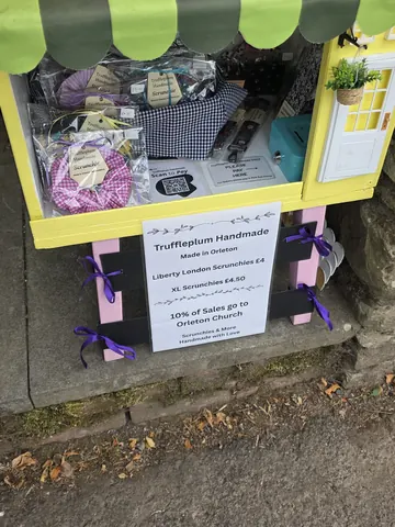 A yellow and pink box with a sign on it.
