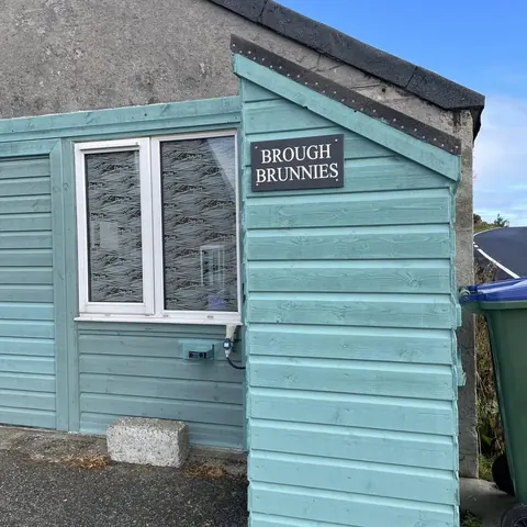 A blue house with a sign that says Brunnies.