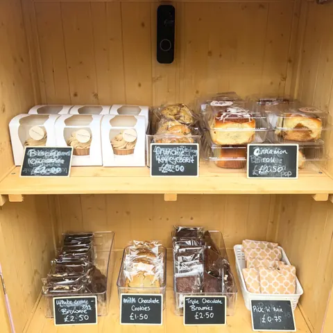 A wooden shelf with various food items on it.