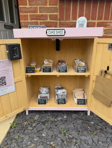 A wooden box with a sign that says "Open" on it.