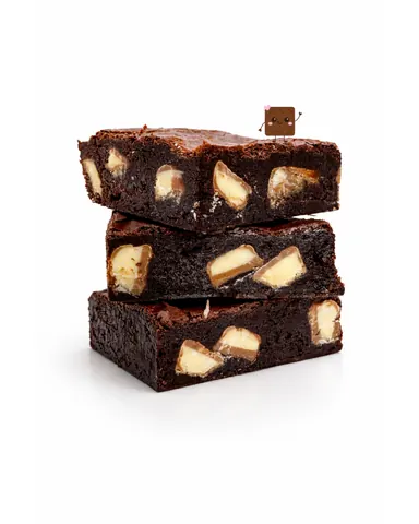 A stack of brownies with nuts on top.