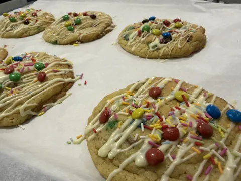 A tray of cookies with various toppings.