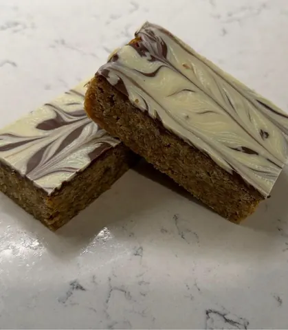 Two pieces of cake on a counter.