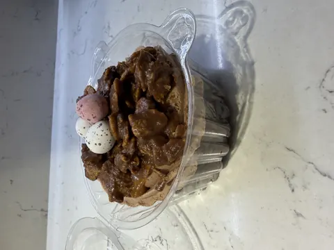 A glass bowl with a cake in it.