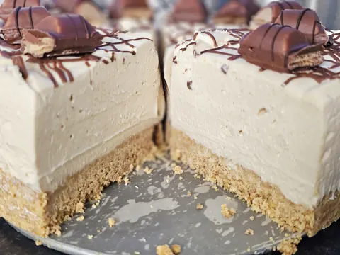 A slice of cake with chocolate and peanut butter toppings.