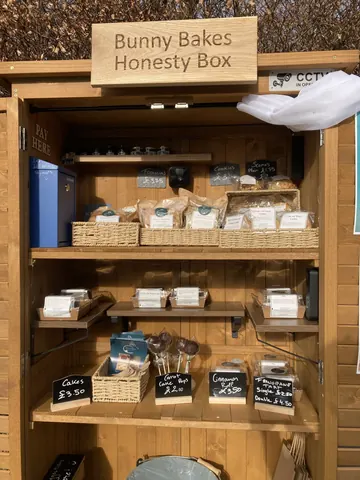A wooden box with a sign that says Honesty Box.