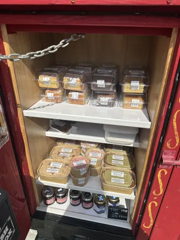 A red box with a white shelf inside.
