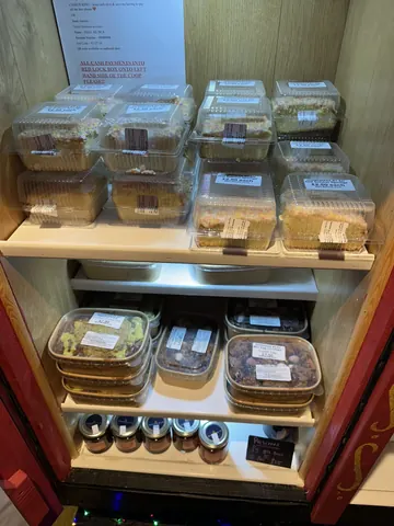A wooden shelf with various food items on it.