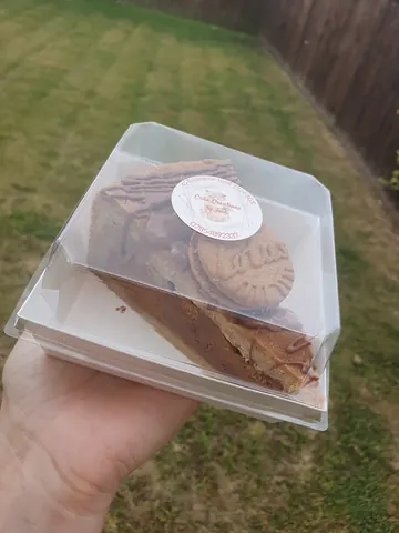 A person is holding a box of cookies.