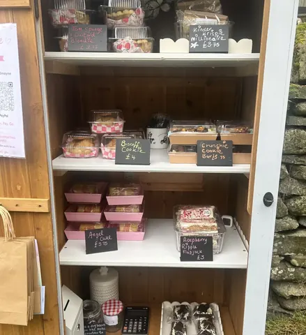 A wooden cabinet with a sign that says "Cake" on it.
