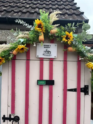 A pink and white striped door with a sign on it.