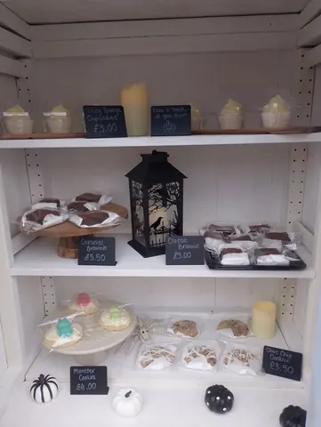 A shelf with a variety of desserts and candles.