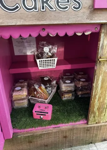 A pink box with a sign that says "please do not touch" and a pink box with a sign that says "please do not touch" and a pink box with a sign that says "please do not touch" and a pink box with a sign that says "please do not touch".