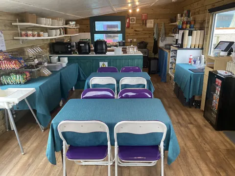 A kitchen with a table and chairs.
