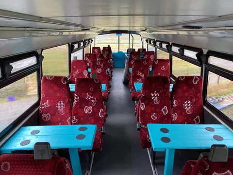 A blue and red table in a bus.