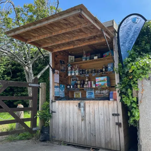 A wooden shed with a sign on the door.