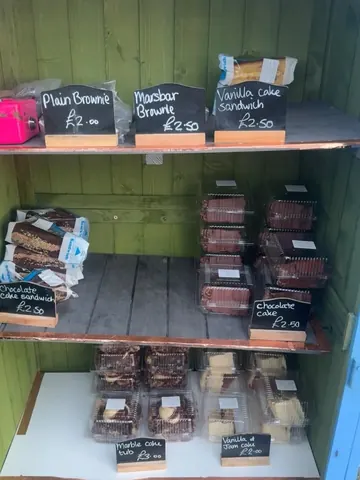 A display case with a variety of desserts in it.