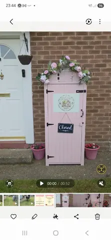 A pink shed with a sign that says "closed" on it.