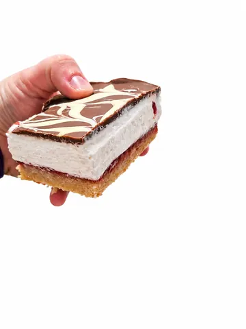 A hand holding a piece of cake.
