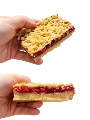 A hand holding a piece of pie.