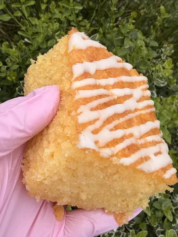 A person is holding a piece of cake.