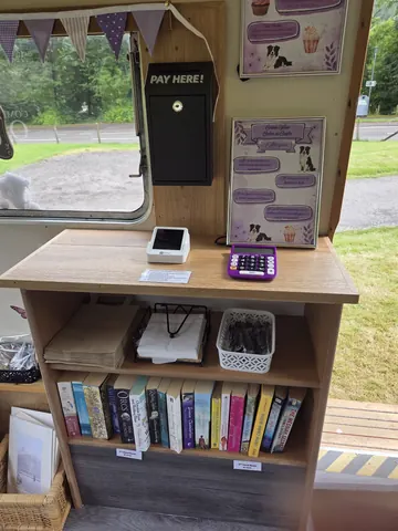 A bookshelf with books and a calculator on it.