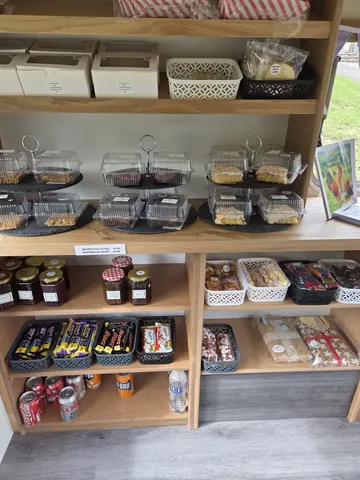 A store with a variety of food items, including candy, snacks, and drinks.