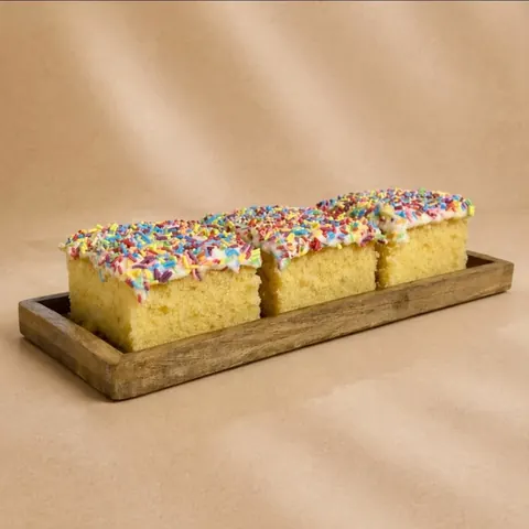 A wooden tray with two cakes on it.