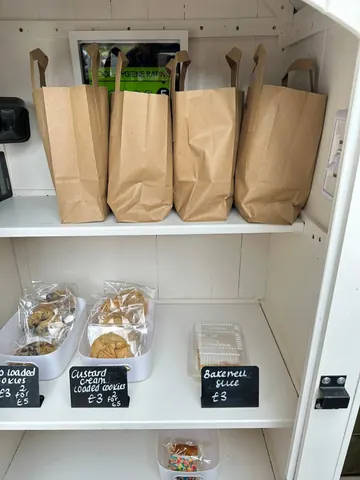 A white shelf with bags of food on it.