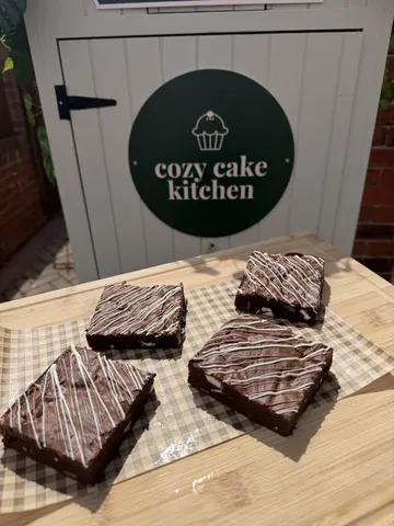 A sign that says cozy cake kitchen.