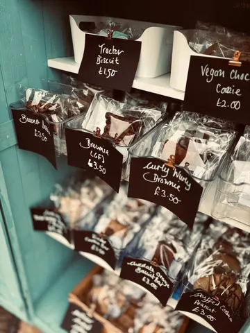 A display of various food items, including cookies, brownies, and other treats.