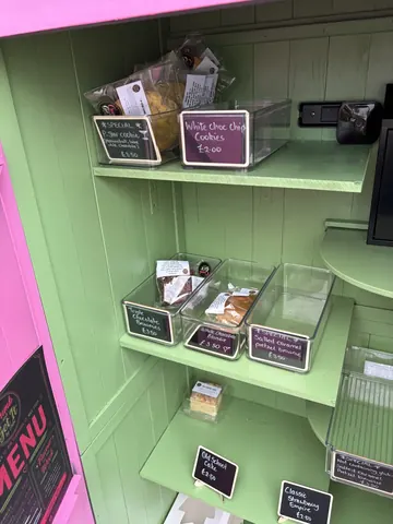 A green shelf with food items on it.