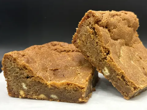 A brown dessert on a white surface.