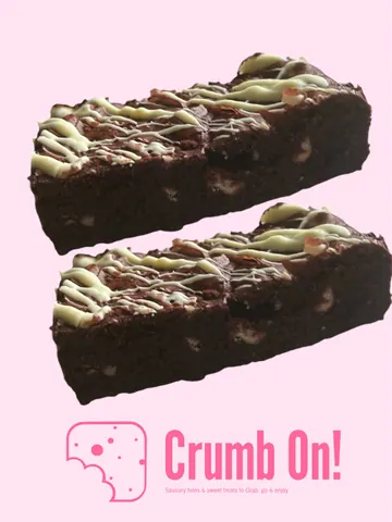 A close up of a chocolate cake with white frosting.