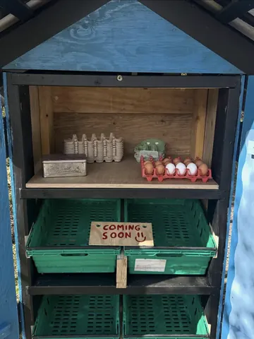 A wooden box with a sign that says "coming soon" on it.