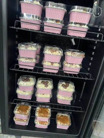 A refrigerator with a shelf full of food.