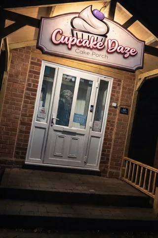 A cupcake shop with a sign that says "Cupcake Daze".